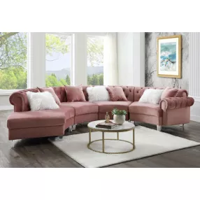 Pink velvet curved four corner sectional in a stylish living room with wood furniture and interior design elements