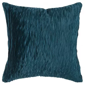 Blue crinkle down filled throw pillow on grey couch with azure and textile details