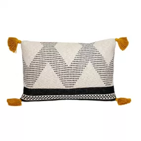 Beige black knit throw pillow with a textured pattern on a basket weave background