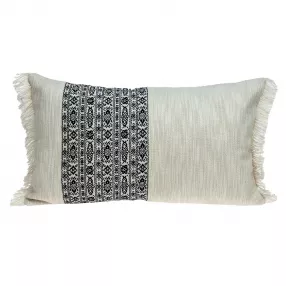 Black and white geometric patterned fringe throw pillow on couch