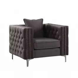 Gray silver velvet tufted chesterfield chair with hardwood armrests in a comfortable rectangle design