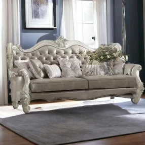 Leather bone sofa with seven toss pillows in a cozy room setup with wood accents