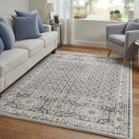 gray abstract stain resistant area rug with brown and black patterns