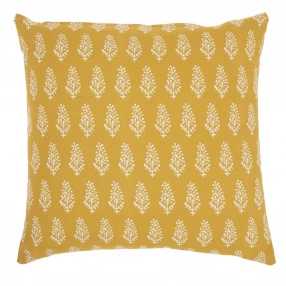 White coral reef pattern throw pillow with brown and orange accents on textile
