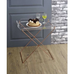 Clear glass gold serving cart with tableware on wood flooring
