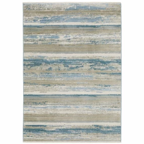 6' X 9' Ivory Beige Grey Blue And Tan Abstract Power Loom Stain Resistant Area Rug With Fringe