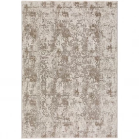 brown oriental area rug with fringe in beige and grey pattern on wood flooring