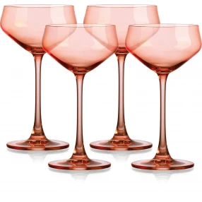 Four translucent blush coral coupe glasses for champagne and alcoholic beverages