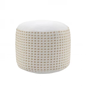 White jute round geometric pouf ottoman in a cozy interior setting