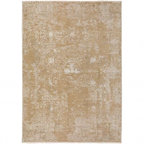 beige oriental area rug with fringe and pattern on wood flooring