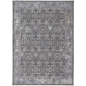 orange floral power loom area rug with grey rectangle pattern on concrete surface