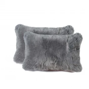 Gray sheepskin pillow made of natural wool and leather fashion accessory
