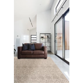 tufted handmade stain resistant area rug in a cozy interior design with grey tones and wooden flooring