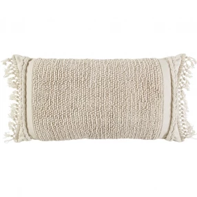 Handwoven braided stripe macrame fringe lumbar pillow with woolen pattern on wooden background