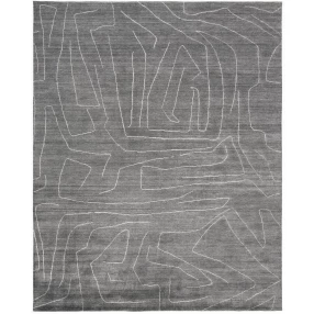 ivory abstract hand woven area rug with plant and monochrome photography