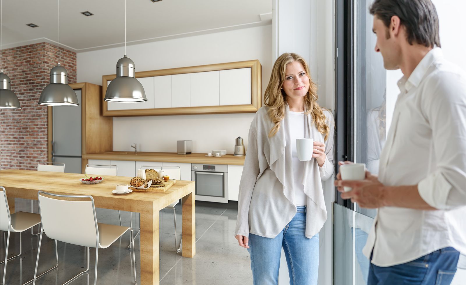 Young couple drinking coffee in a modern kitchen